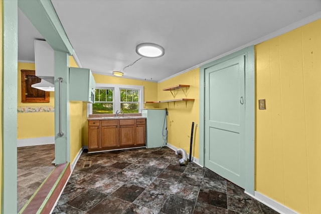 1098 Mount Vernon Rd, Tunnel Hill, GA 30755 - kitchen with baseboards, dark stone finish floors, a sink, open shelves, and ornamental molding