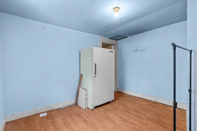 1098 Mount Vernon Rd, Tunnel Hill, GA 30755 - unfurnished bedroom featuring freestanding refrigerator, light wood finished floors, and baseboards