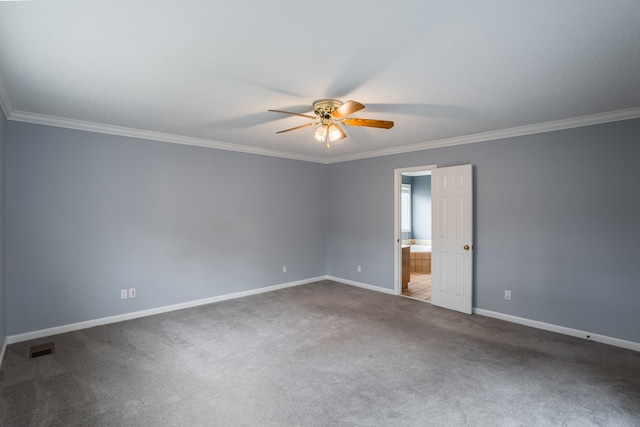carpeted spare room with visible vents, baseboards, a ceiling fan, and crown molding