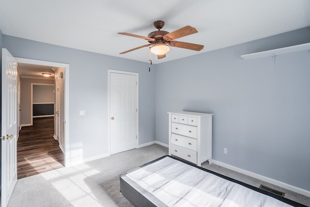 unfurnished bedroom with visible vents, baseboards, ceiling fan, and carpet flooring
