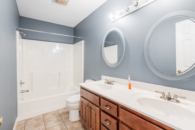 full bath featuring tile patterned floors, toilet, a textured ceiling, and a sink