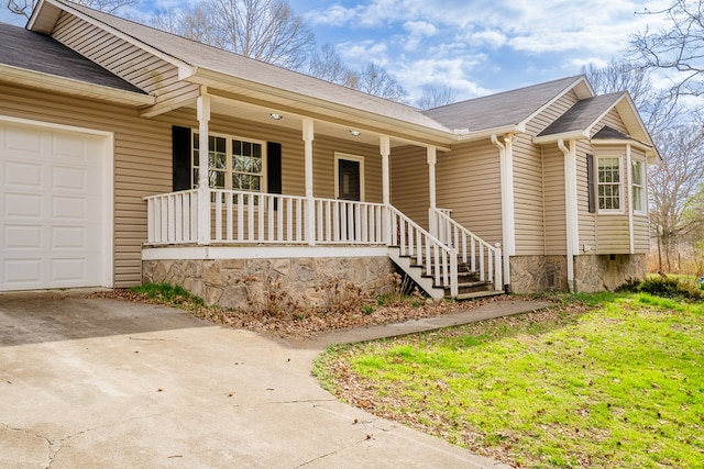 property entrance with a porch, concrete driveway, an attached garage, and roof with shingles
