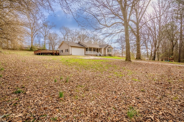 view of property exterior with covered porch and a garage