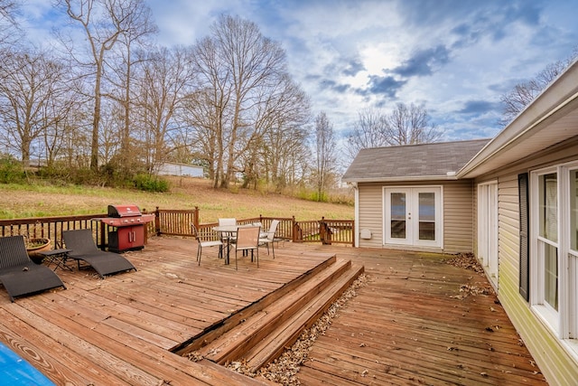 wooden terrace featuring outdoor dining area and french doors