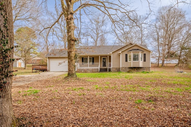 view of front facade with an attached garage, a porch, and driveway