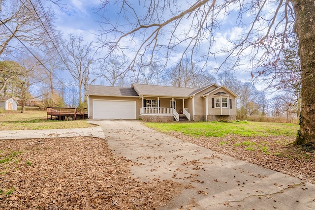 view of front of property with a garage, covered porch, and driveway