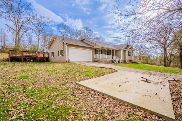 view of front of house with a porch, a front yard, driveway, and a garage