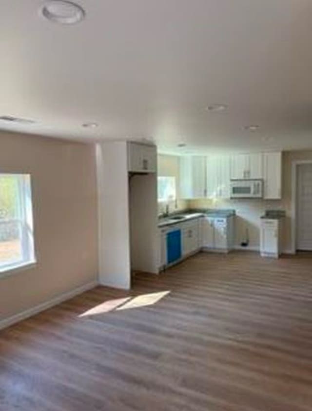 kitchen featuring white cabinetry and dark hardwood / wood-style flooring