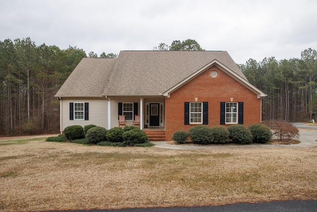 view of front facade with covered porch and a front lawn