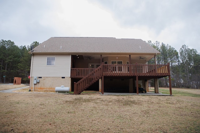 back of house featuring ceiling fan, a patio, a deck, and a lawn