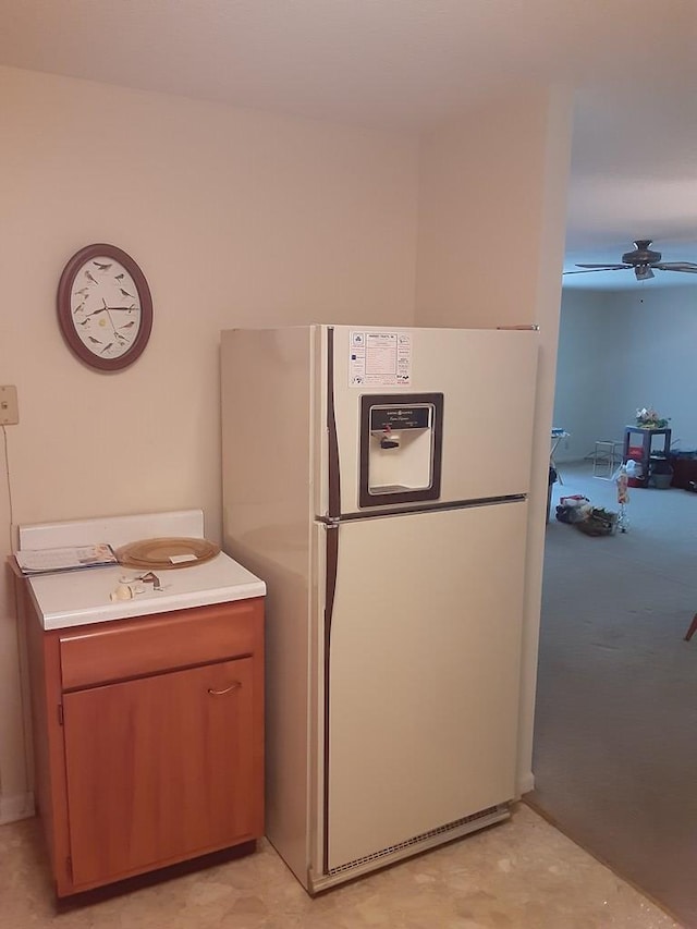 kitchen with white refrigerator with ice dispenser and ceiling fan