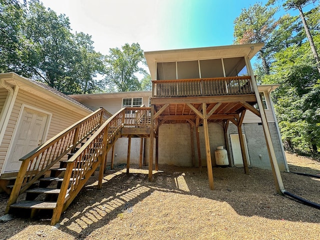 back of house with a sunroom and a deck