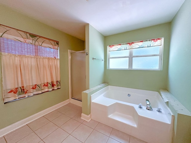 bathroom featuring tile patterned flooring and shower with separate bathtub