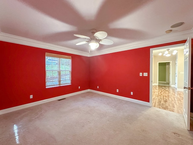 empty room with crown molding, ceiling fan, and carpet flooring