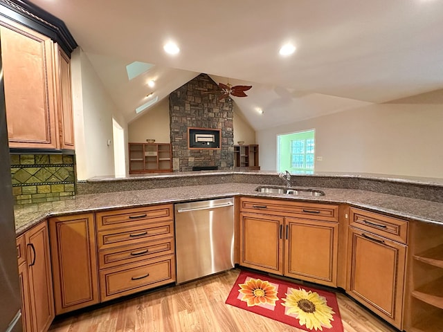 kitchen with dishwasher, sink, ceiling fan, and light hardwood / wood-style floors