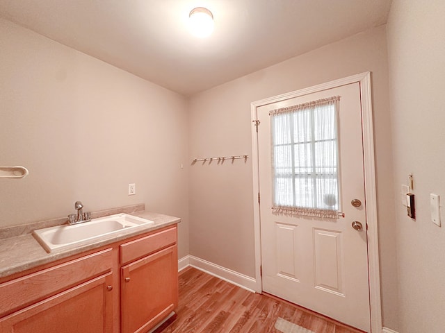 interior space with sink and light hardwood / wood-style flooring