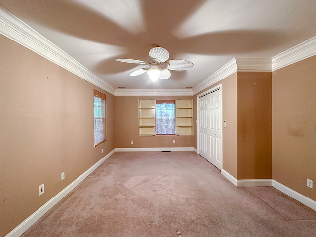 unfurnished bedroom featuring ornamental molding, carpet, ceiling fan, and a closet