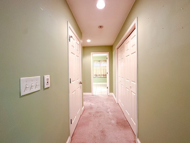 hallway featuring light carpet