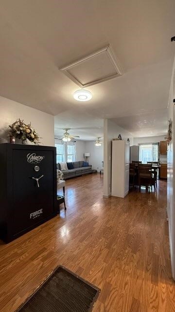 hall featuring a healthy amount of sunlight and wood finished floors