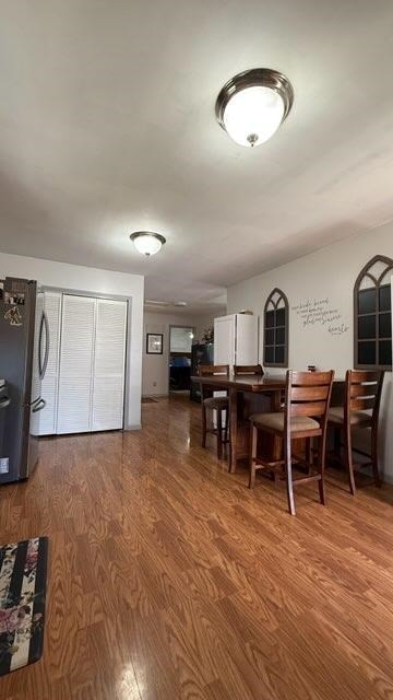 dining space with wood finished floors