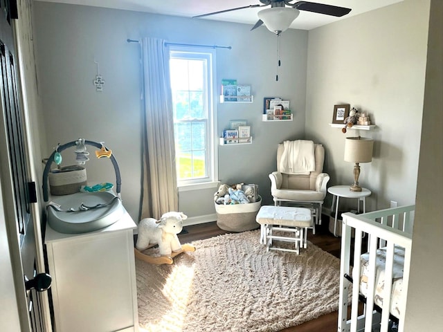 41 Magnolia Ct, Rydal, GA 30171 - bedroom with a crib, multiple windows, wood finished floors, and a ceiling fan