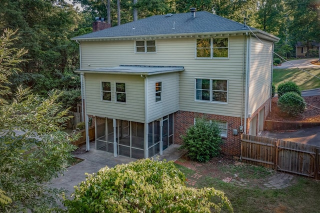 rear view of property with a sunroom