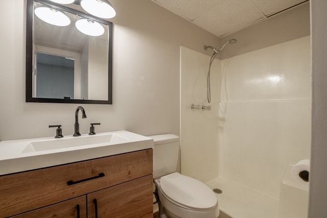 bathroom featuring vanity, toilet, and walk in shower