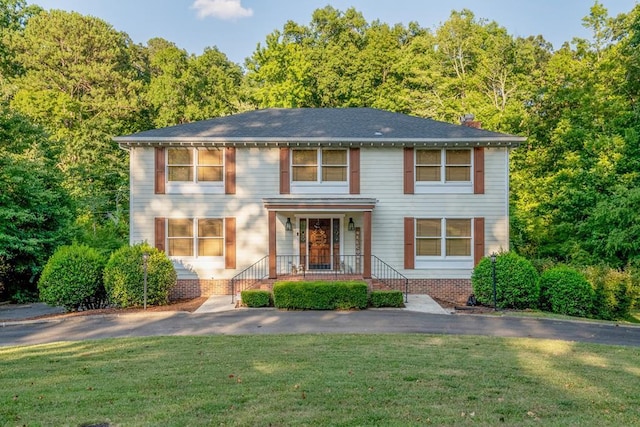 view of front of property with a porch and a front lawn