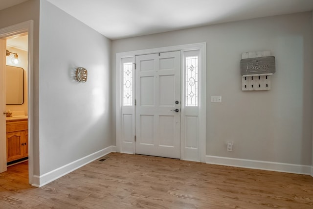 entrance foyer with plenty of natural light and light wood-type flooring