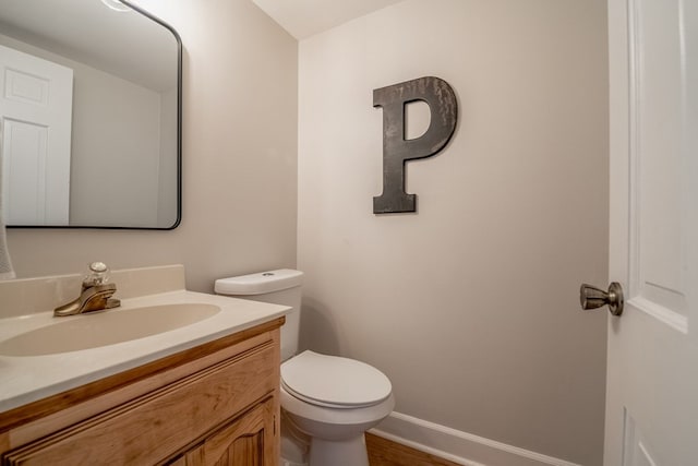 bathroom with vanity, hardwood / wood-style floors, and toilet