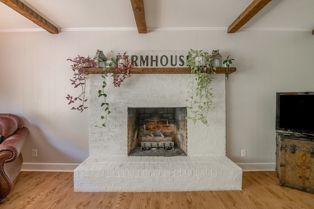 room details featuring wood-type flooring, beam ceiling, and a brick fireplace