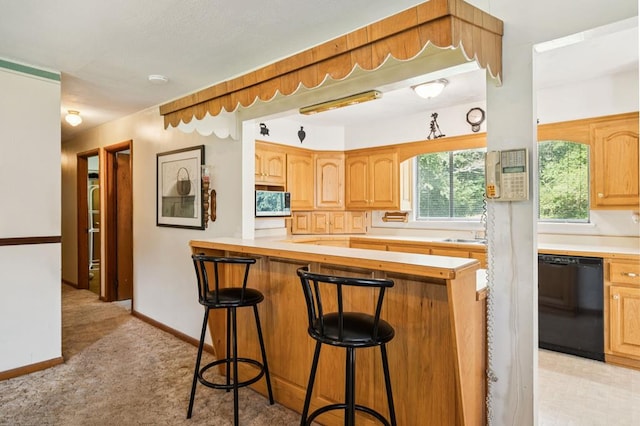 183 Long Hollow Rd, Rock Spring, GA 39736 - kitchen with a kitchen breakfast bar, black dishwasher, light countertops, light colored carpet, and stainless steel microwave