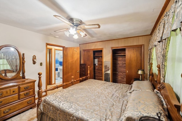 183 Long Hollow Rd, Rock Spring, GA 39736 - bedroom with wood walls, two closets, ornamental molding, a ceiling fan, and carpet