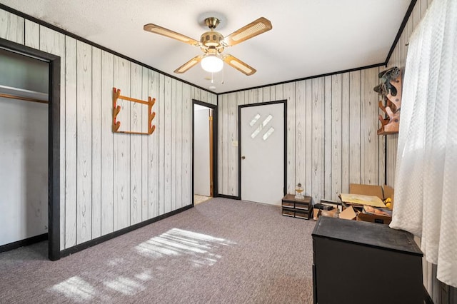 183 Long Hollow Rd, Rock Spring, GA 39736 - living area with carpet, a ceiling fan, wood walls, and crown molding