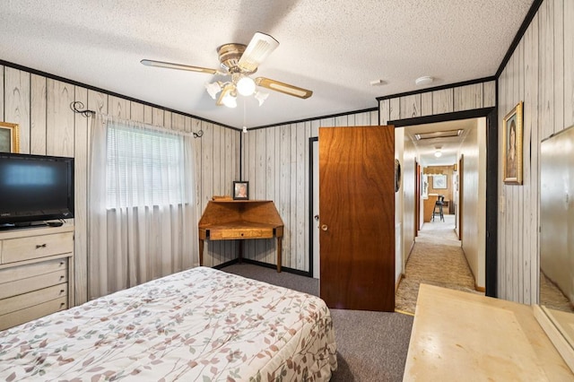 183 Long Hollow Rd, Rock Spring, GA 39736 - carpeted bedroom with a textured ceiling, a ceiling fan, wooden walls, and crown molding
