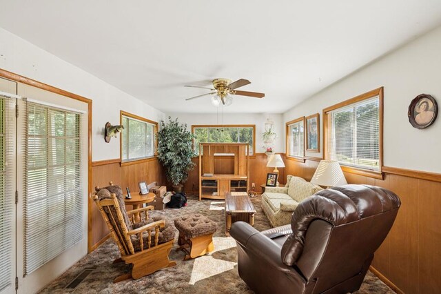 183 Long Hollow Rd, Rock Spring, GA 39736 - living room with wainscoting, wooden walls, and a ceiling fan