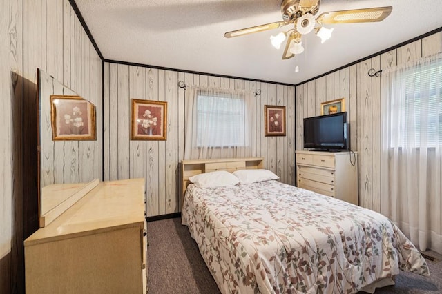 183 Long Hollow Rd, Rock Spring, GA 39736 - bedroom featuring dark colored carpet, crown molding, a textured ceiling, ceiling fan, and wood walls