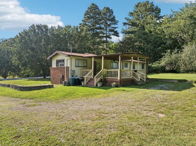 183 Long Hollow Rd, Rock Spring, GA 39736 - view of front of property featuring covered porch, a front yard, and brick siding