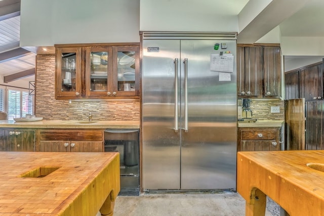 1301 Morton Dr, Dalton, GA 30720 - kitchen featuring stainless steel built in fridge, wood counters, decorative backsplash, glass insert cabinets, and beamed ceiling