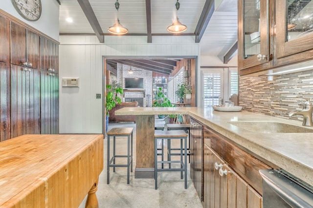 1301 Morton Dr, Dalton, GA 30720 - kitchen featuring a sink, stainless steel dishwasher, beamed ceiling, backsplash, and glass insert cabinets