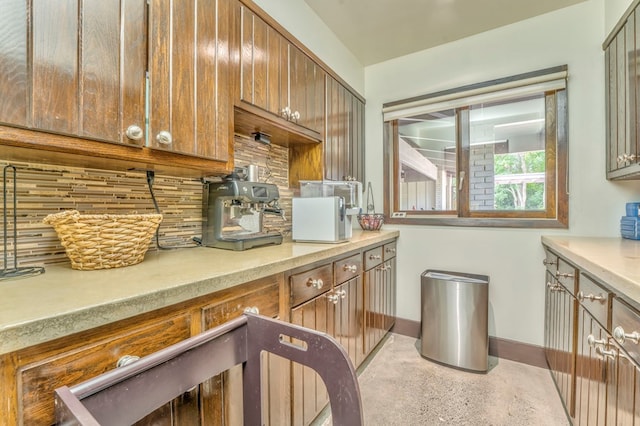 1301 Morton Dr, Dalton, GA 30720 - kitchen with tasteful backsplash, baseboards, light countertops, and brown cabinetry