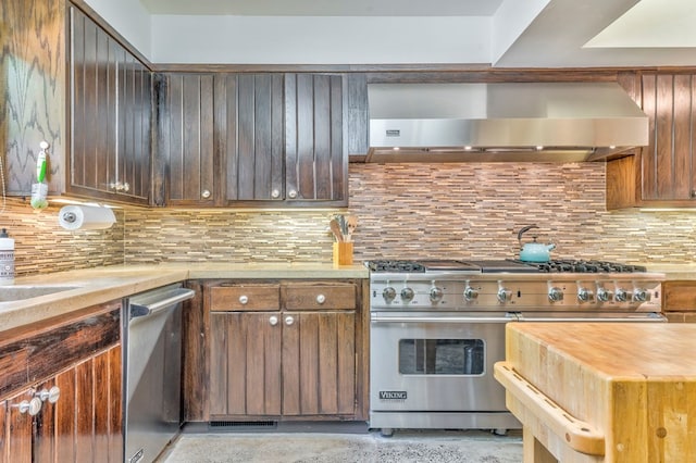 1301 Morton Dr, Dalton, GA 30720 - kitchen with appliances with stainless steel finishes, wall chimney exhaust hood, butcher block counters, and decorative backsplash