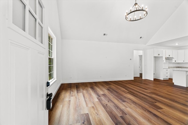 3005 Crystal Mark Ln, Dalton, GA 30721 - unfurnished living room with high vaulted ceiling, a chandelier, and dark wood-style flooring