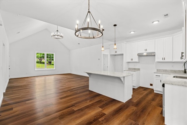 3005 Crystal Mark Ln, Dalton, GA 30721 - kitchen with under cabinet range hood, a chandelier, a center island, open floor plan, and dark wood-style flooring