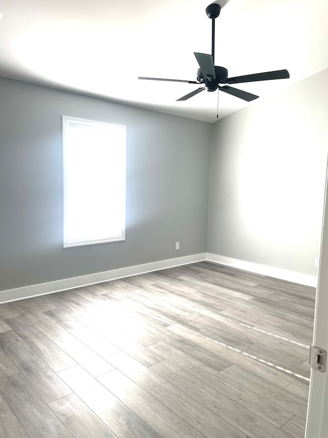 spare room featuring ceiling fan and light hardwood / wood-style flooring