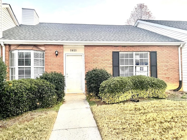 doorway to property featuring a lawn