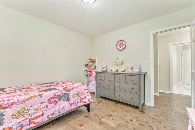 432 Castle Rd, Dalton, GA 30720 - bedroom with light hardwood / wood-style floors and a textured ceiling