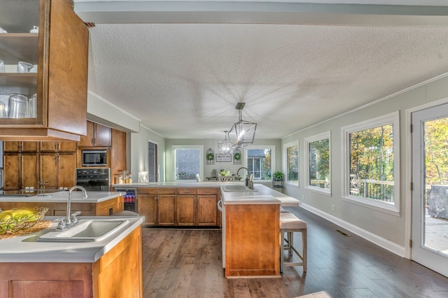 432 Castle Rd, Dalton, GA 30720 - kitchen with sink, a center island with sink, a kitchen breakfast bar, pendant lighting, and oven