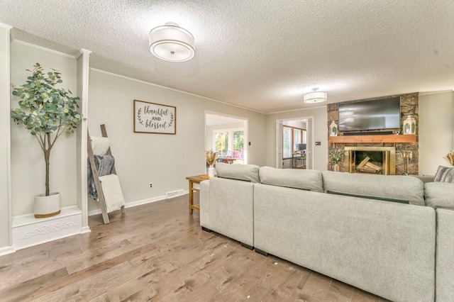 432 Castle Rd, Dalton, GA 30720 - living room with crown molding, hardwood / wood-style floors, a textured ceiling, and a fireplace