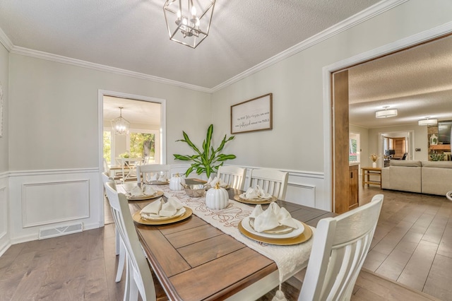 432 Castle Rd, Dalton, GA 30720 - dining room featuring an inviting chandelier, crown molding, wood-type flooring, and a textured ceiling